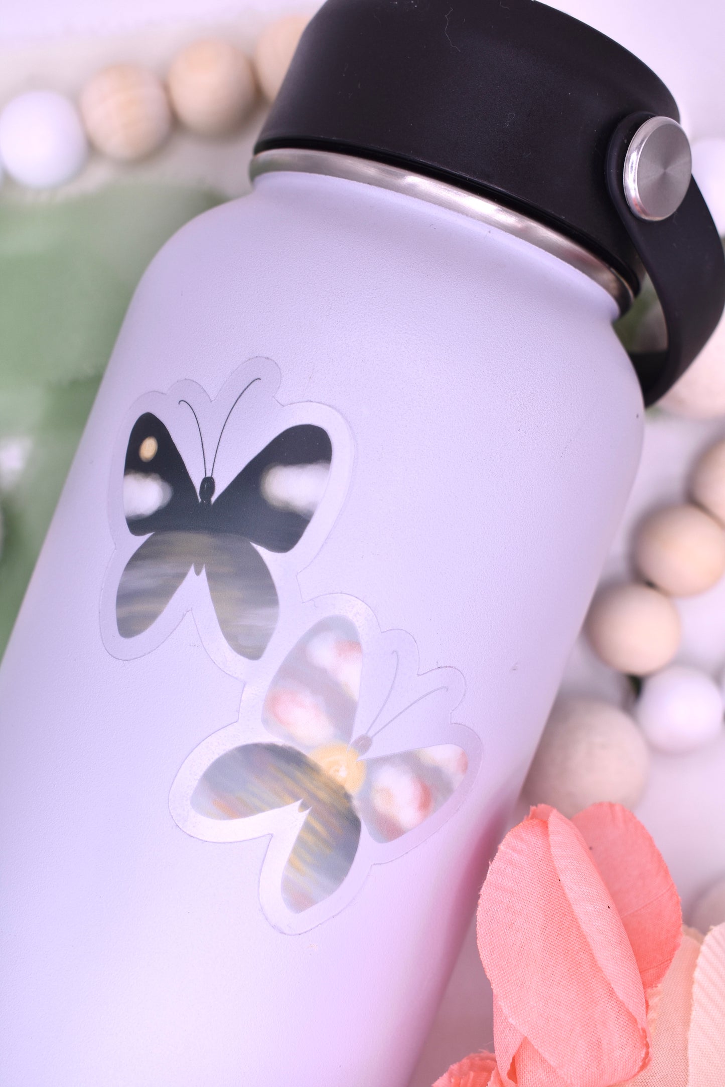 Night and day beach/ocean inspired butterflies- clear background sticker featured on a grey waterbottle