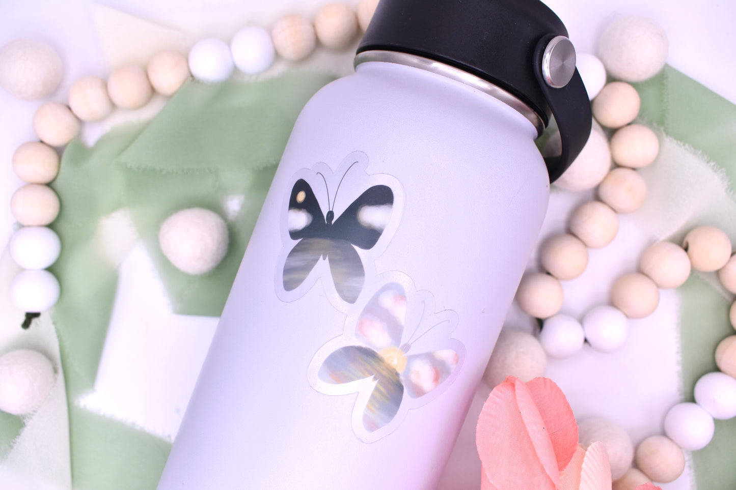 Night and day beach/ocean inspired butterflies- clear background sticker featured on a grey waterbottle